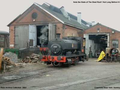 A view of the Cranmore shed yard ( Cranmore End ) with 5637 in steam just visible in the shed doorway and 705 parked up on the workshop road but take a look at the state of the shed roof not long before it was replaced. Picture taken Sunday 1st June 2003